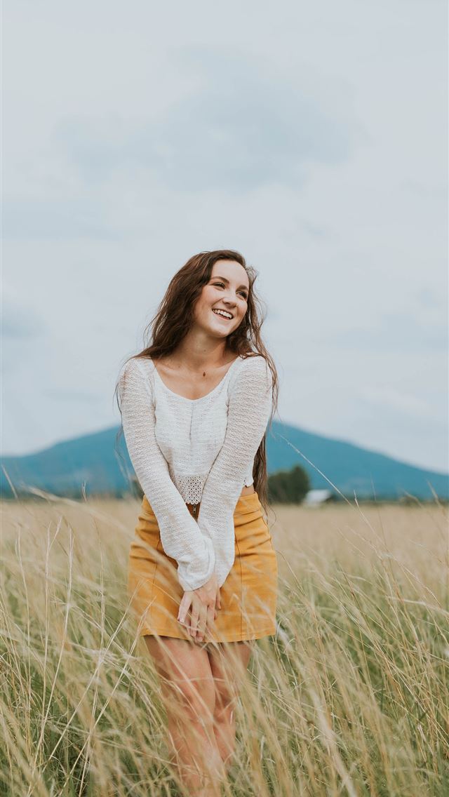 1284x2778 woman wearing brown long sleeved shirt on green gr... -  iPhone Wallpaper