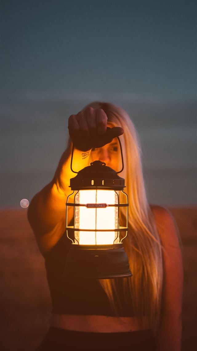 1284x2778 shallow focus photography of woman holding lantern - denver iPhone Wallpaper