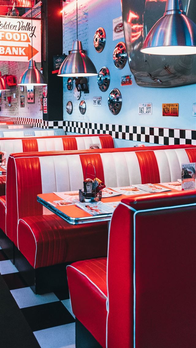 1284x2778 red padded sofa and tables inside building - retro iPhone Wallpaper