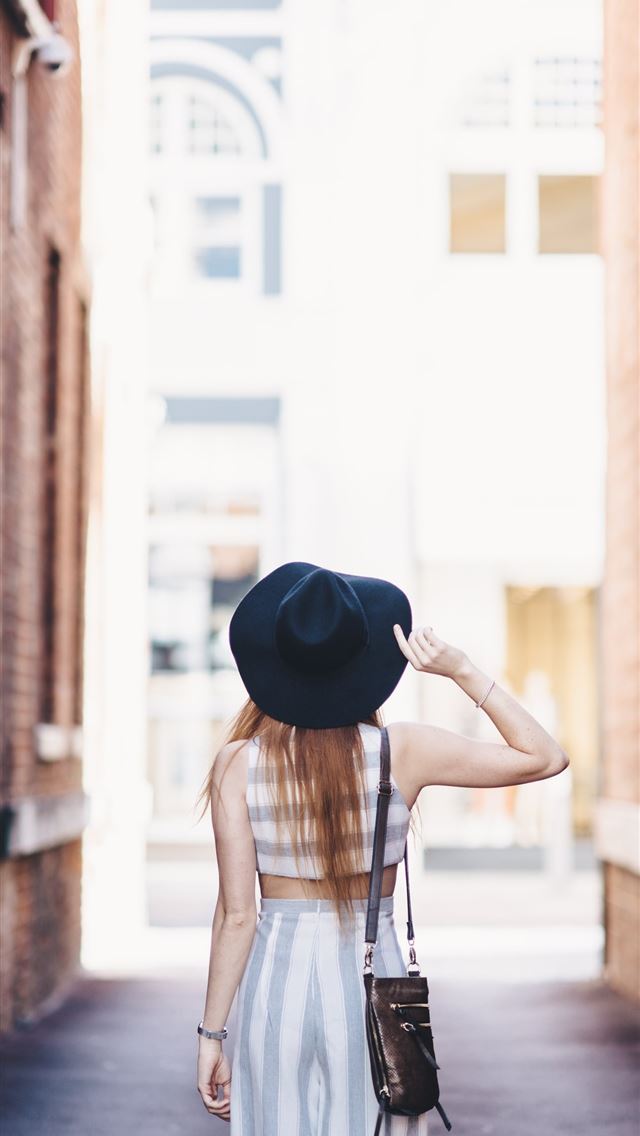 1284x2778 woman standing on pathway holding hat - australia iPhone Wallpaper