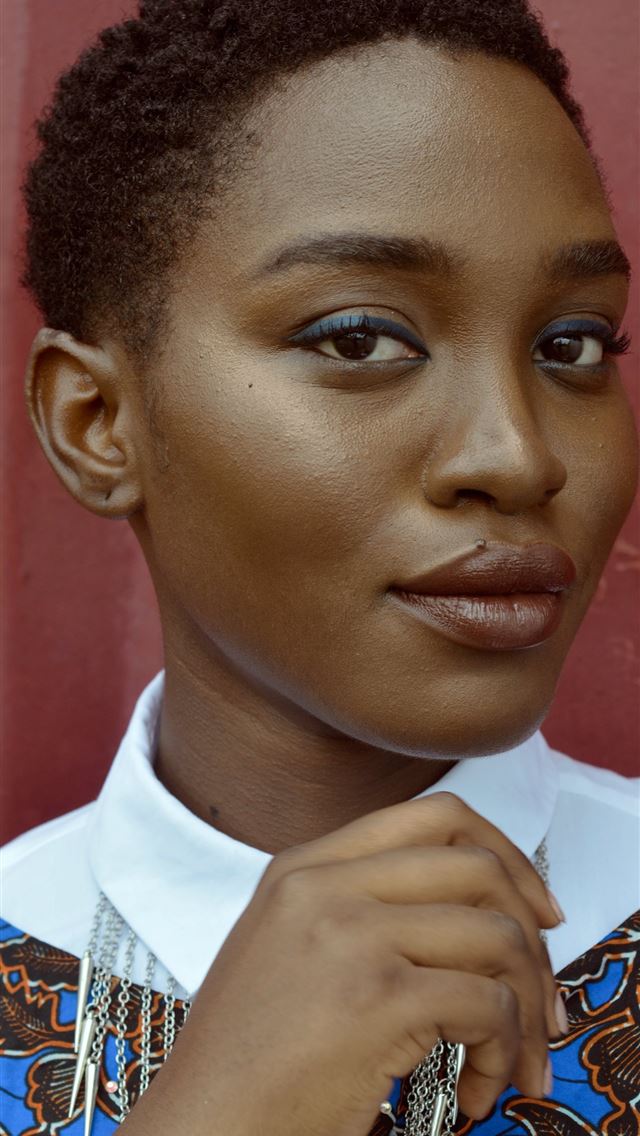 1284x2778 women holding her collar standing near wall - lagos iPhone Wallpaper
