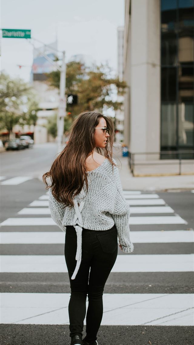 1284x2778 woman looking towards her right while walking alon... - united states iPhone Wallpaper