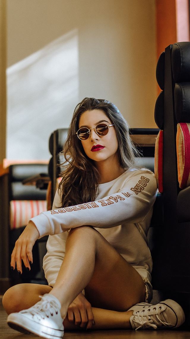 1284x2778 woman sitting near sofa with cross legs - girl iPhone Wallpaper