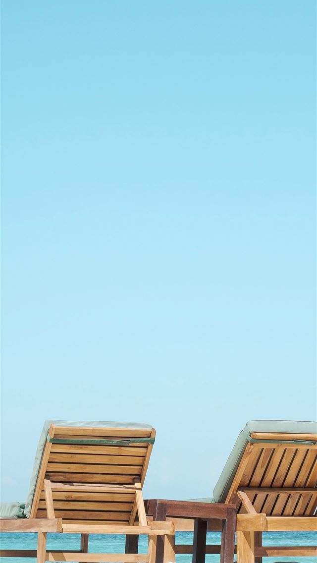 1284x2778 two brown wooden outdoor chaise loungers on beach - indonesia iPhone Wallpaper