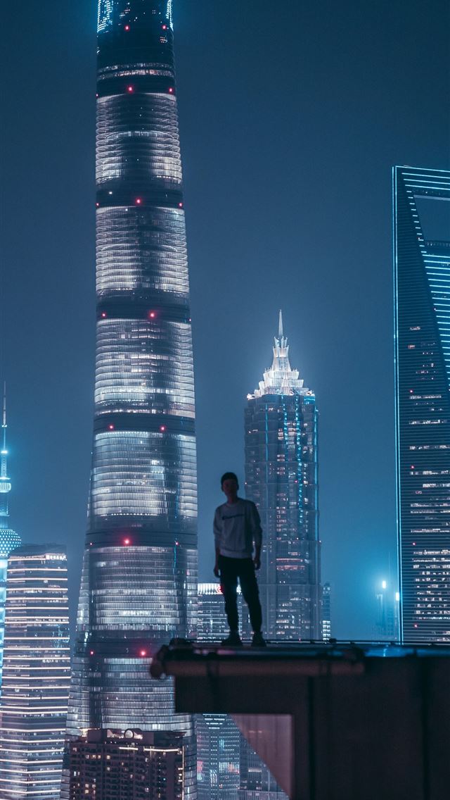 1284x2778 man standing on top of skyscraper - city iPhone Wallpaper