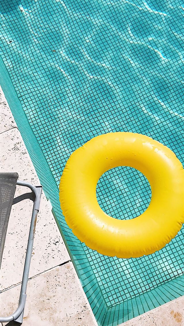 1284x2778 yellow plastic round toy on green table - summer iPhone Wallpaper