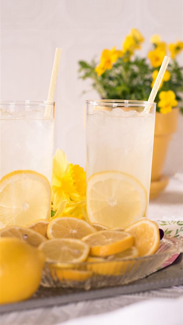 1284x2778 sliced lemon beside two clear drinking glasses - yellow iPhone Wallpaper