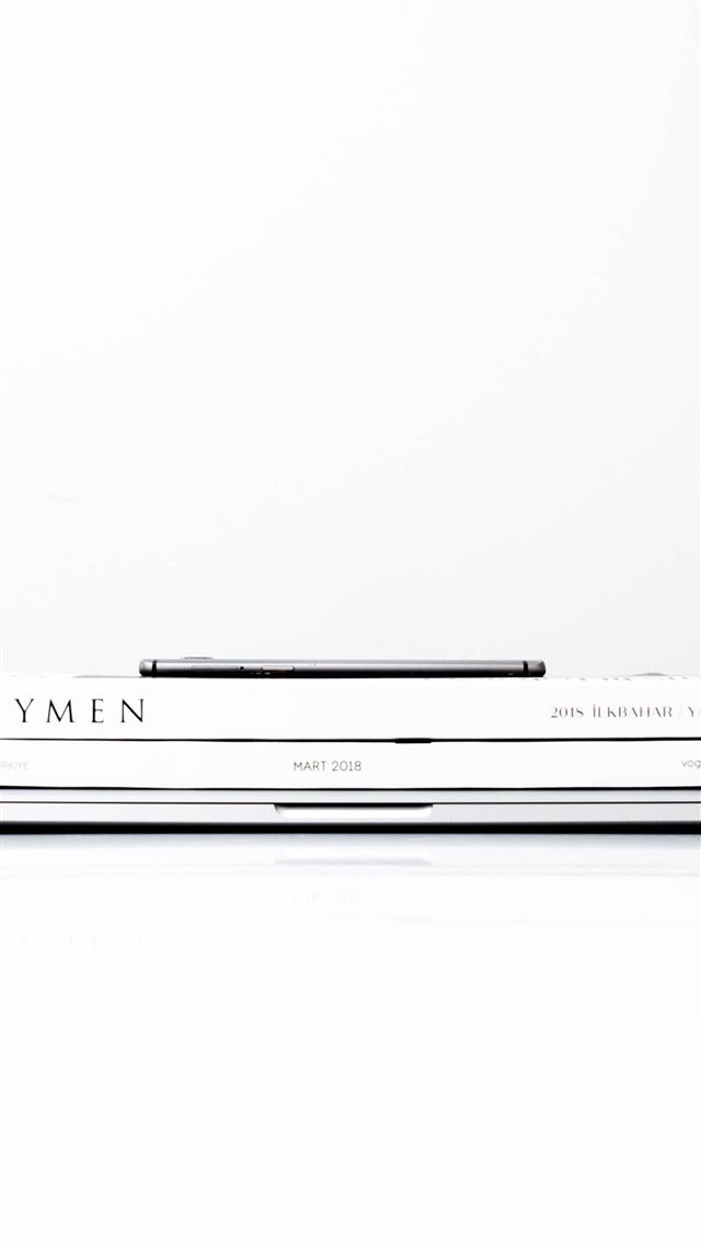 1284x2778 silver laptop computer with two books on the top - turkey iPhone Wallpaper