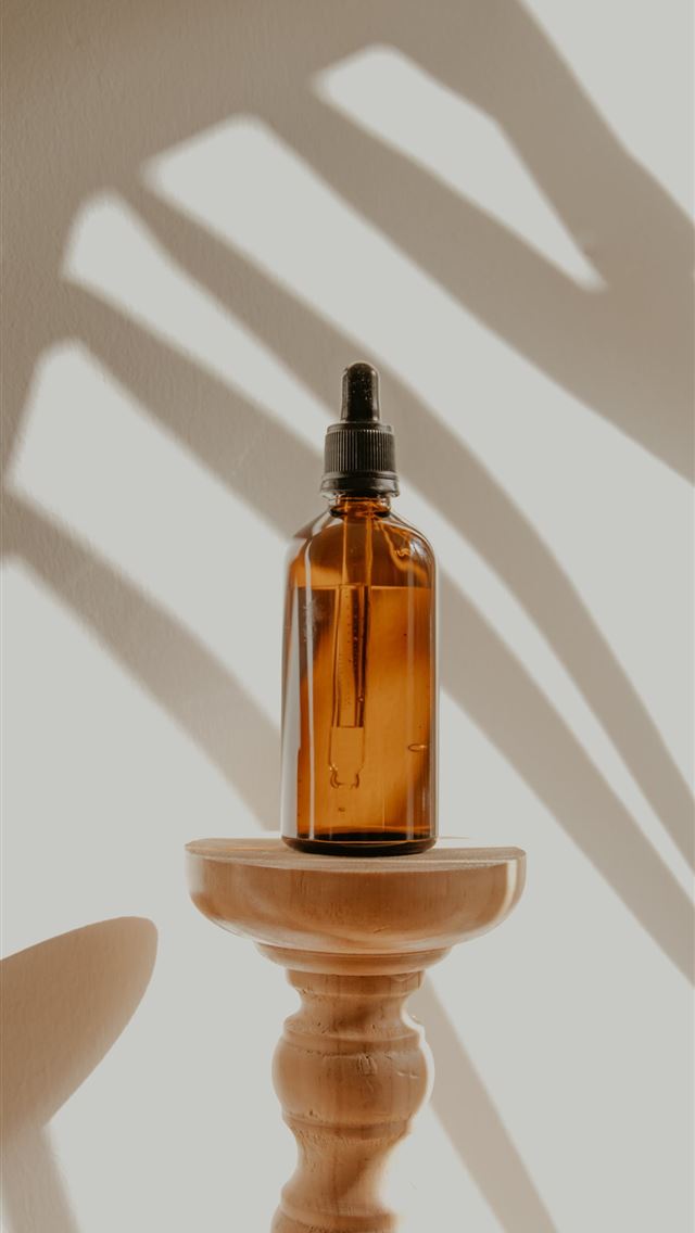 1284x2778 clear glass bottle on white wooden round table -  iphone 13 Wallpaper