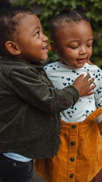 boy and girl surrounded by plants wallpaper