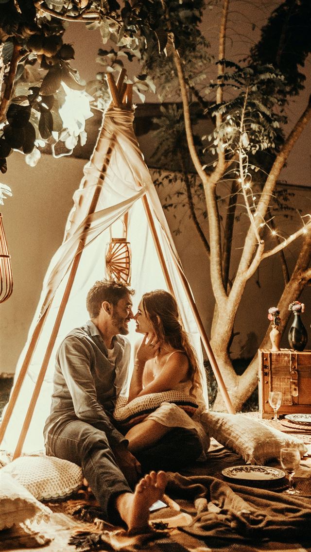1284x2778 smiling man and woman inside tipi tent - love iPhone Wallpaper