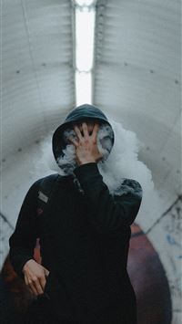 man standing wearing black coat covering his face ... wallpaper