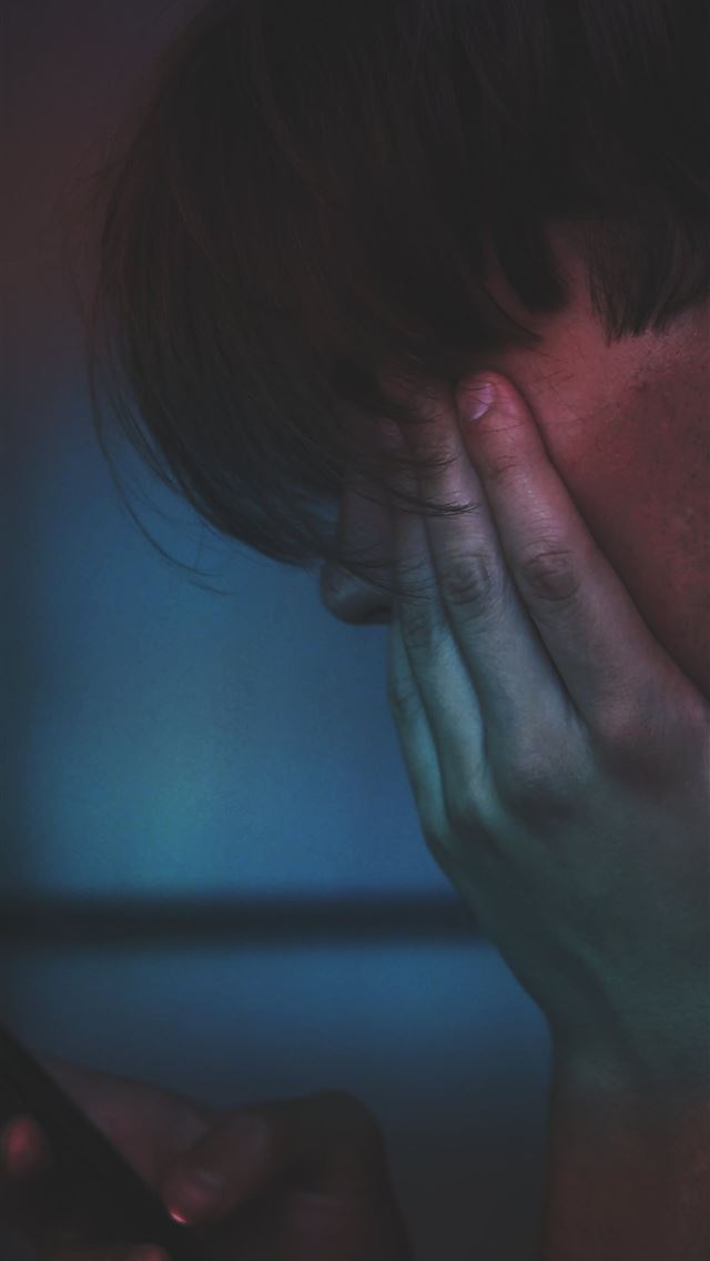 1284x2778 man holding smartphone in close up photography - vienna iPhone Wallpaper