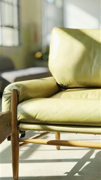 yellow leather sofa near window wallpaper