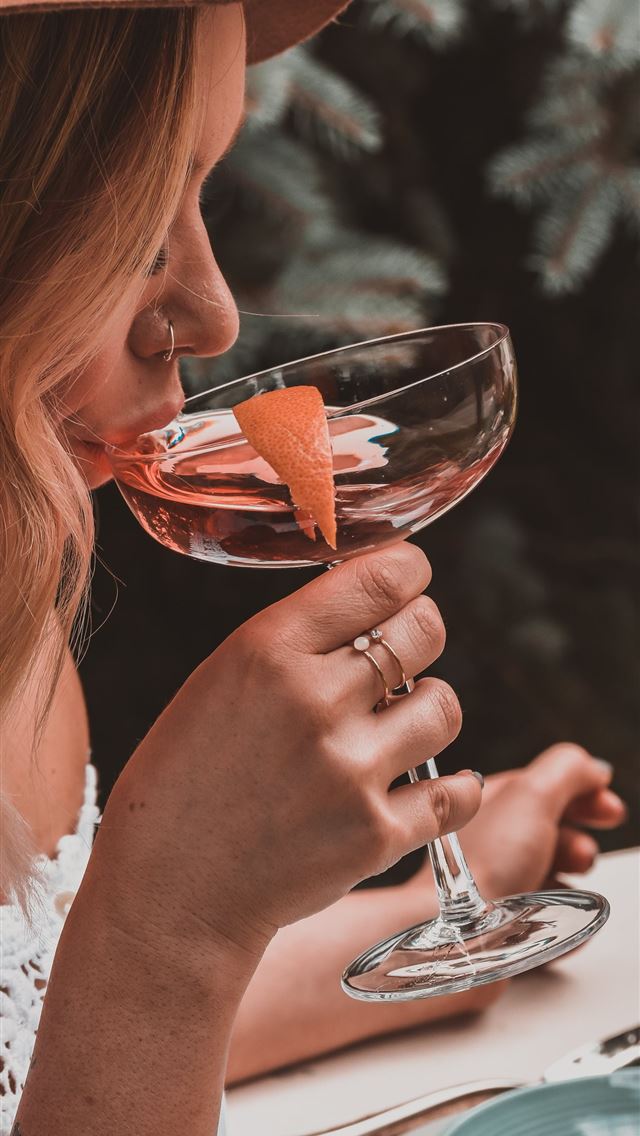 1284x2778 woman holding cocktail glass -  iphone 13 Wallpaper