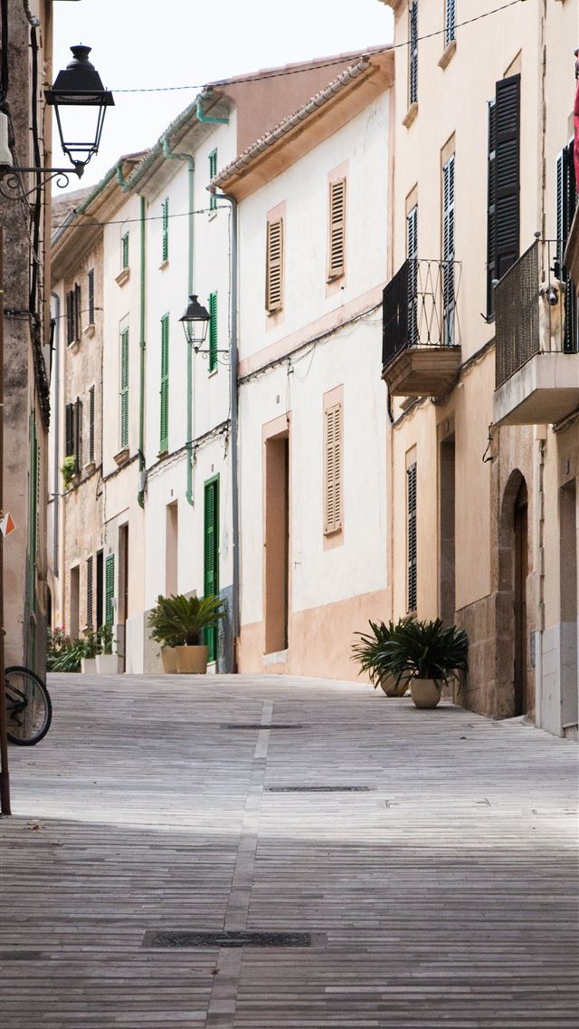 1284x2778 straight alley road with brown buildings - spain iPhone Wallpaper