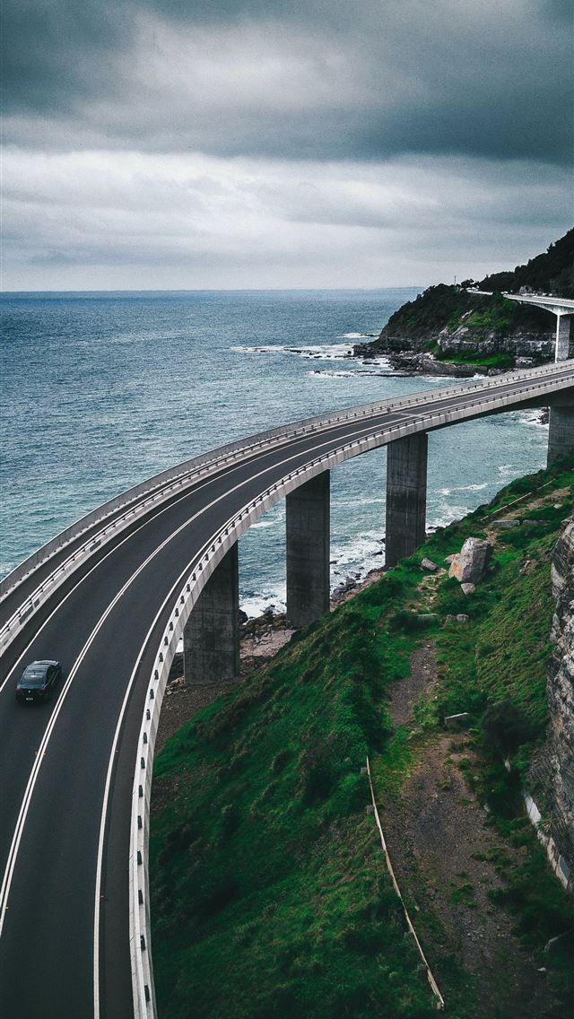 1284x2778 gray concrete road bridge near hill and ocean unde... - australia iPhone Wallpaper