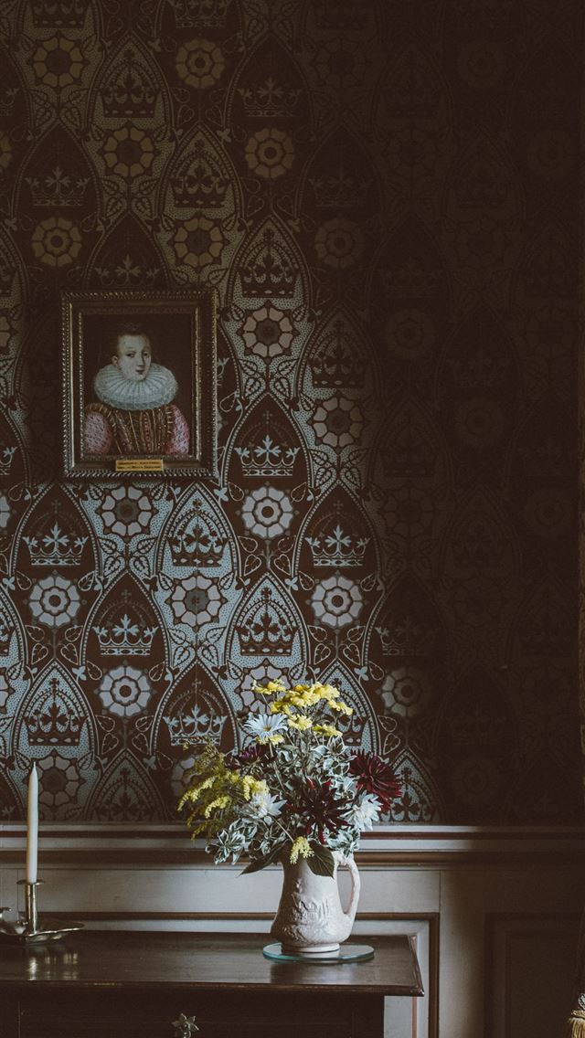 1284x2778 painting hanged on wall over flower arrangement on... -  iphone 13 Wallpaper