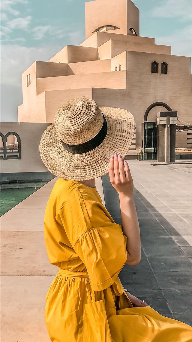 1284x2778 woman wearing sun hat and yellow dress in front of... - qatar iPhone Wallpaper