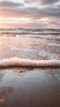 selective focus photo of water waves on sand wallpaper