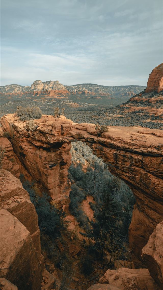 1284x2778 brown rock formation under white clouds during day... - az iPhone Wallpaper