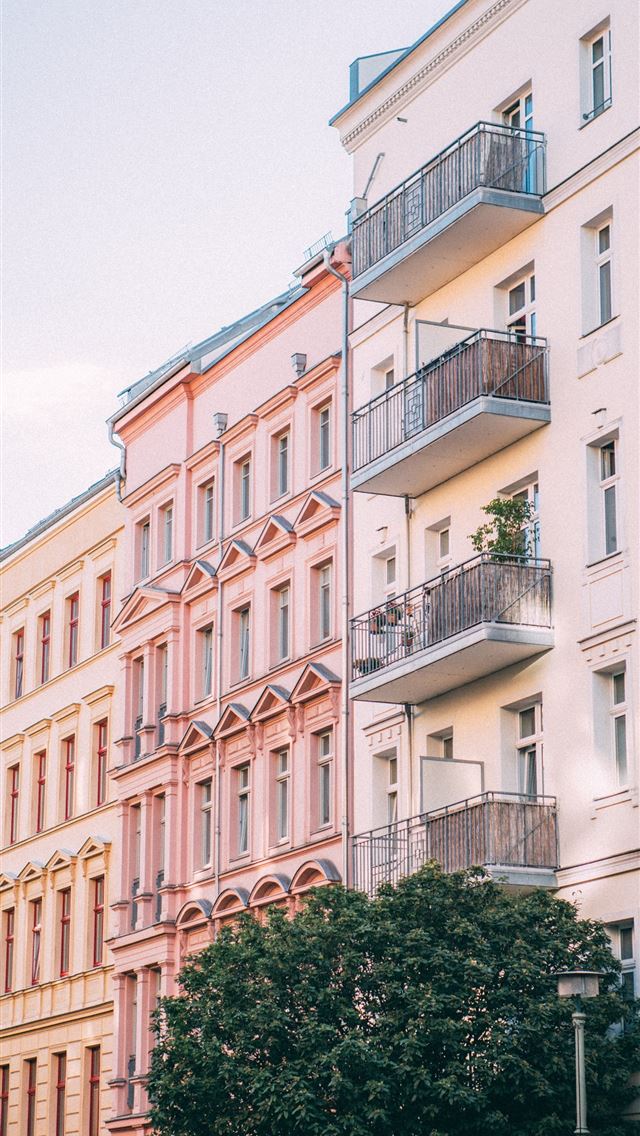 1284x2778 low angle photo of building - pink iPhone Wallpaper
