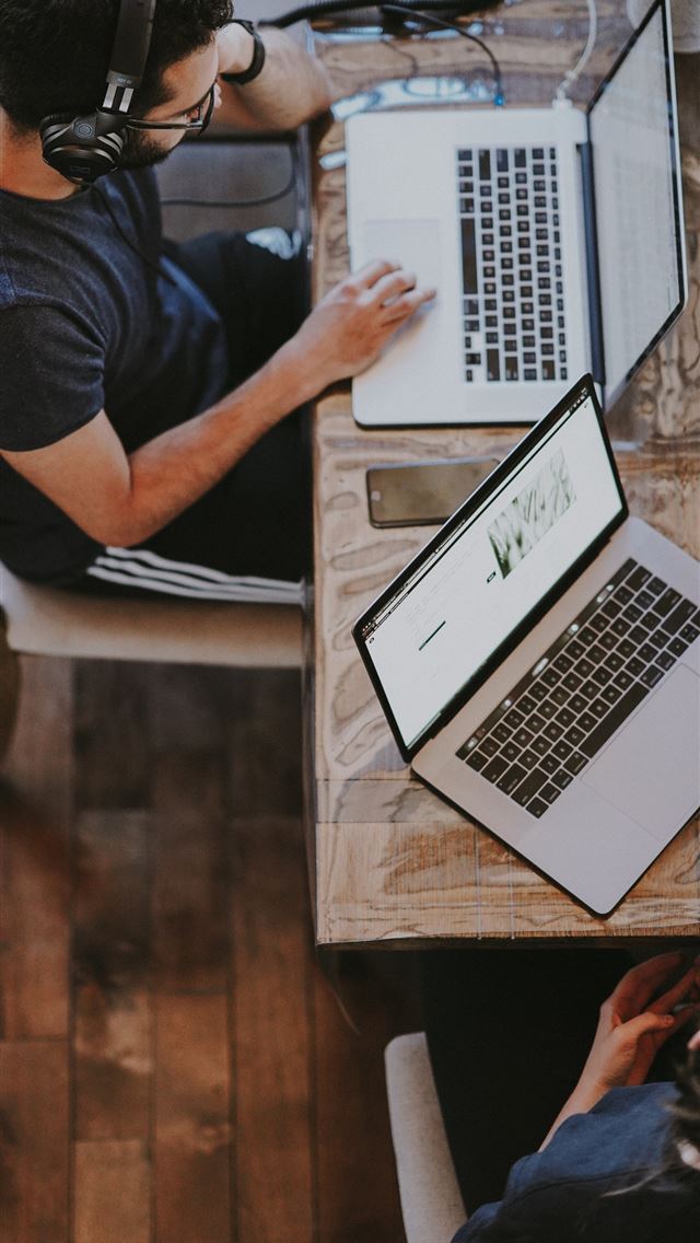 1290x2796 man sitting on chair and looking laptop computer -  iphone 14 Wallpaper