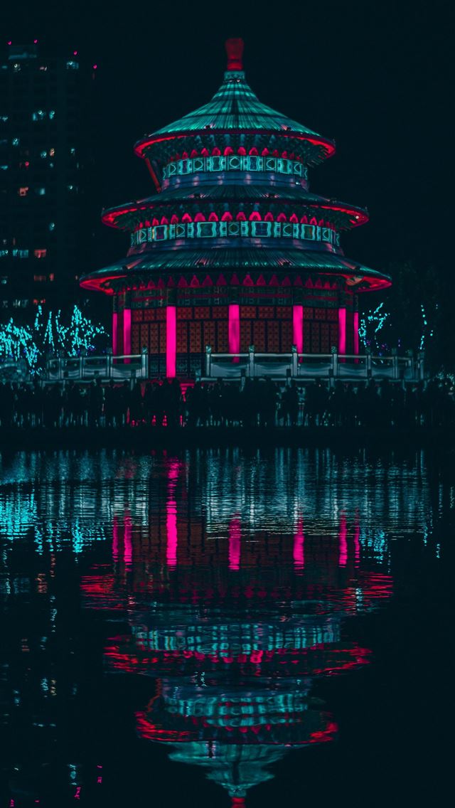 1290x2796 green and red lighted building near body of water ... - cyan iPhone Wallpaper