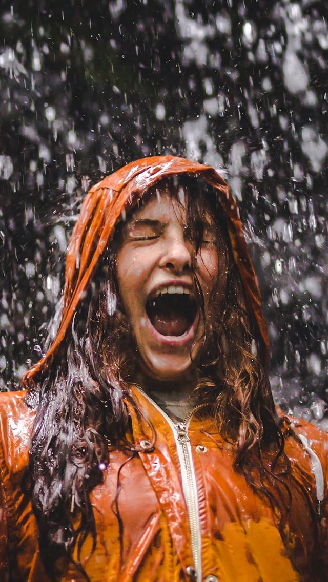 1125x2436 close up photo of woman in orange coat -  iphone 14 Wallpaper