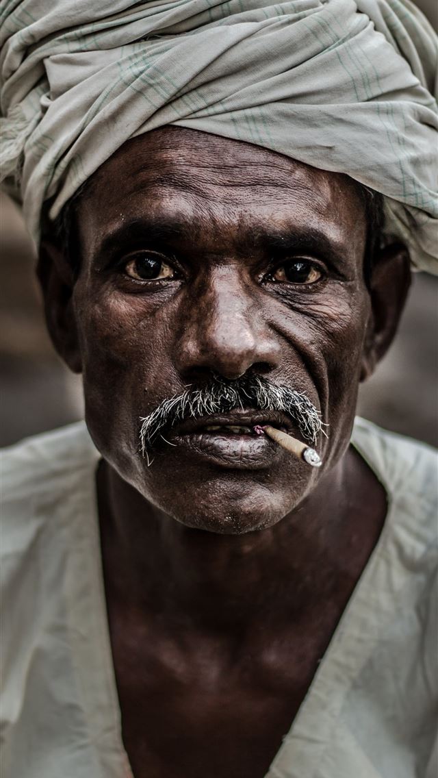 1290x2796 man wearing gray turban smoking cigarette in close... -  iPhone Wallpaper