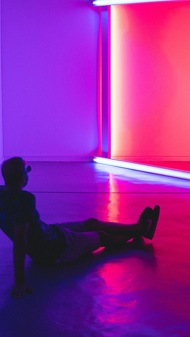 1290x2796 man sitting on floor facing a lighted room area -  iphone 14 Wallpaper