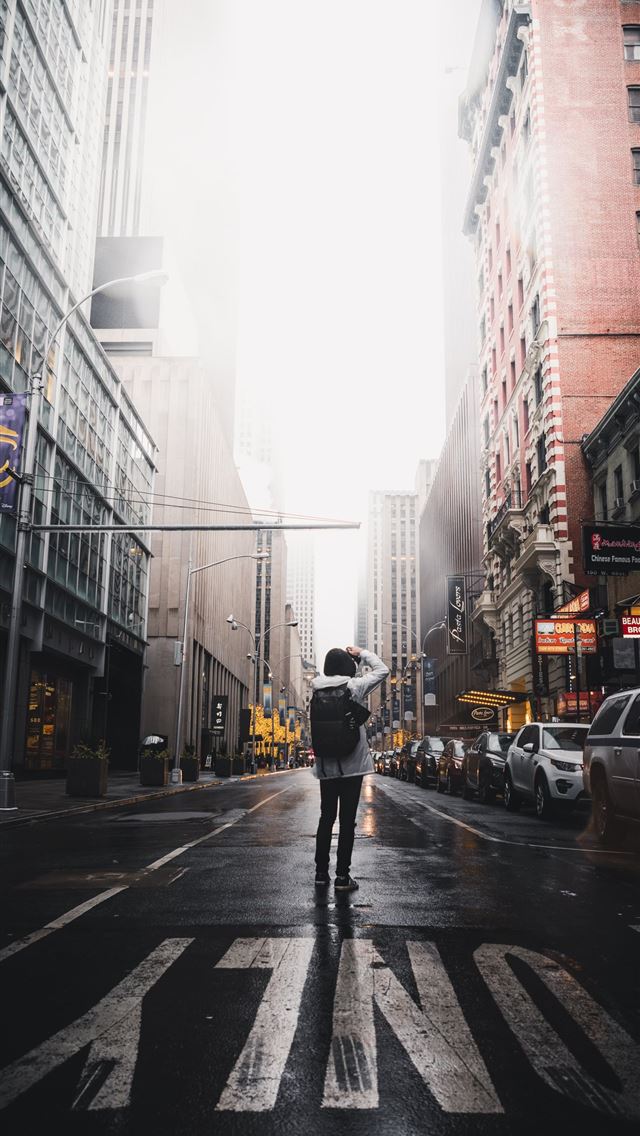 1290x2796 person taking photo of buildings - city iPhone Wallpaper