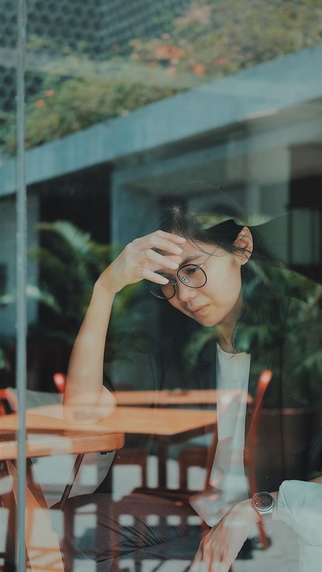 1290x2796 woman touching her forehead -  iphone 14 Wallpaper