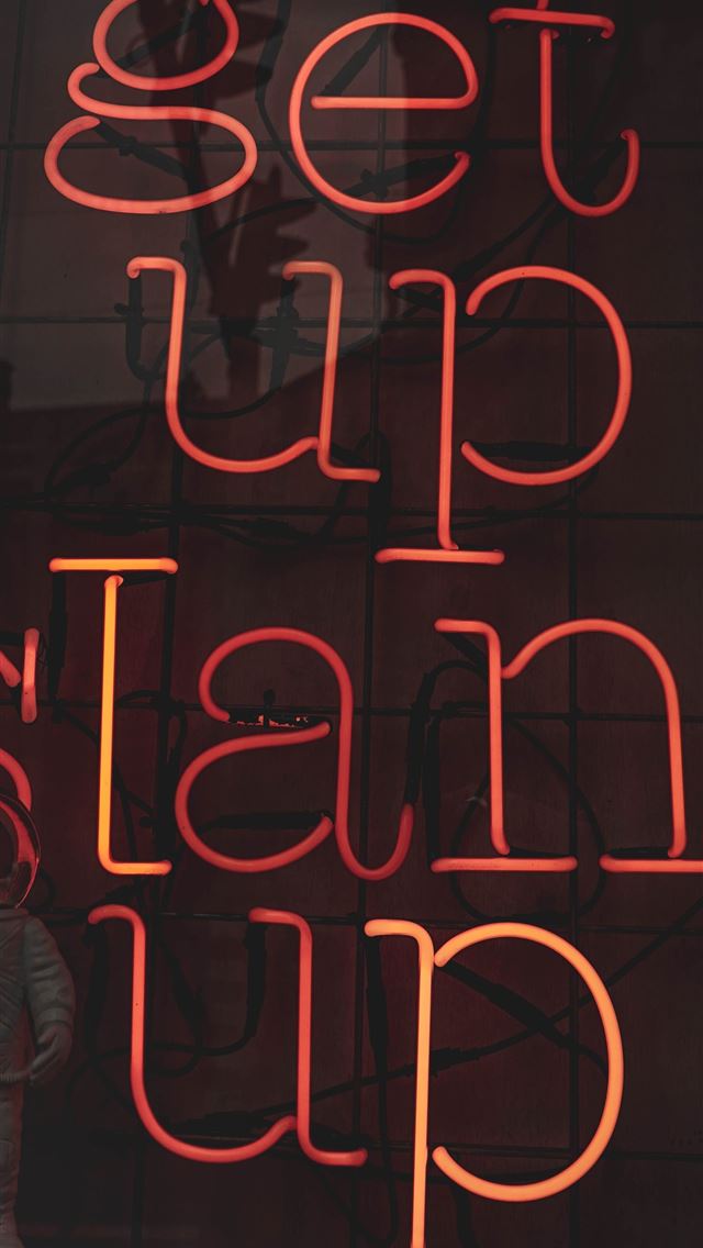 1290x2796 Neon light at the By Popular Demand storefront in ... - person iPhone Wallpaper