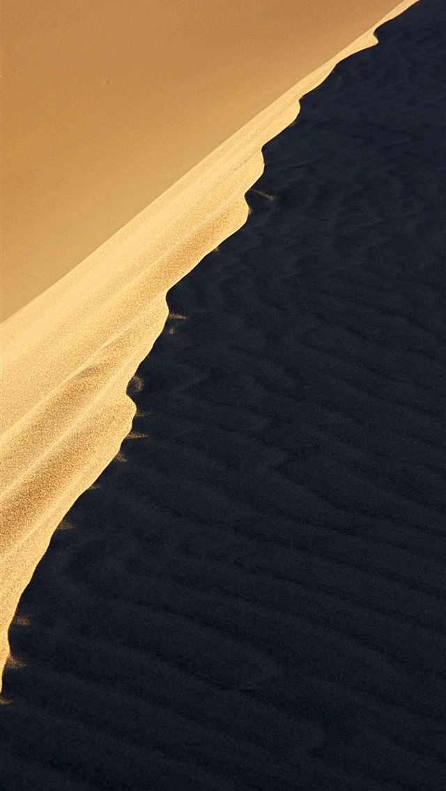 1290x2796 a person riding a surfboard on top of a sandy beac... - desert iPhone Wallpaper