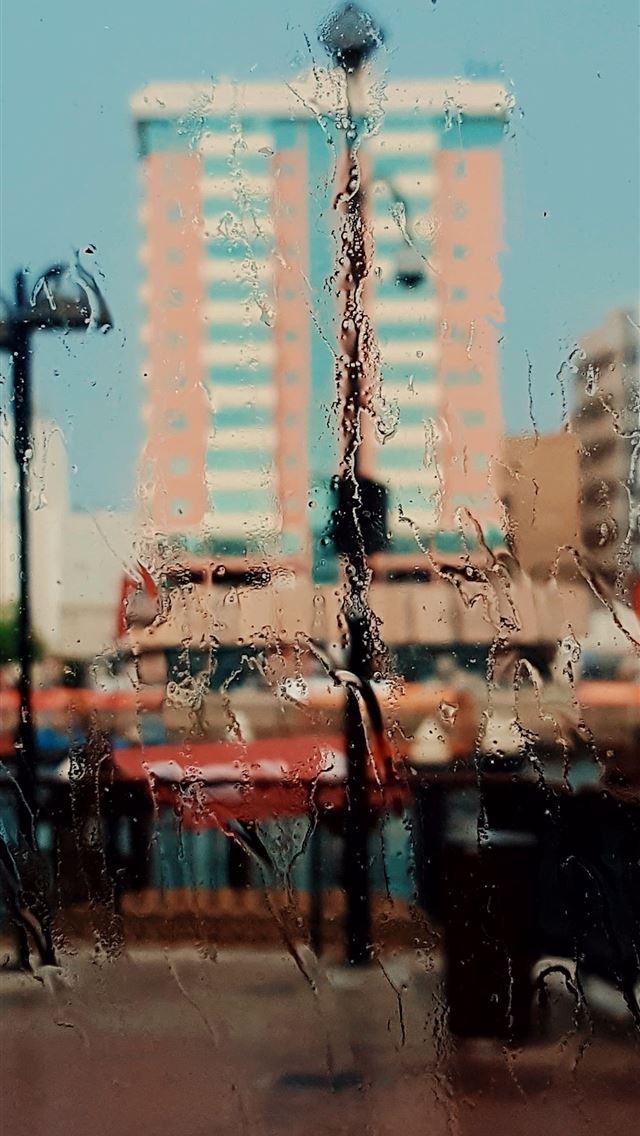 1290x2796 a view of a city through a rainy window - art iPhone Wallpaper