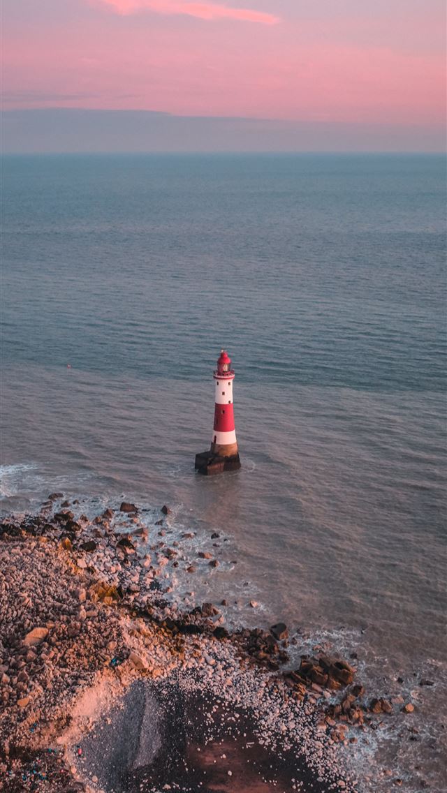 1290x2796 a red and white light house in the middle of the o... - lighthouse iPhone Wallpaper