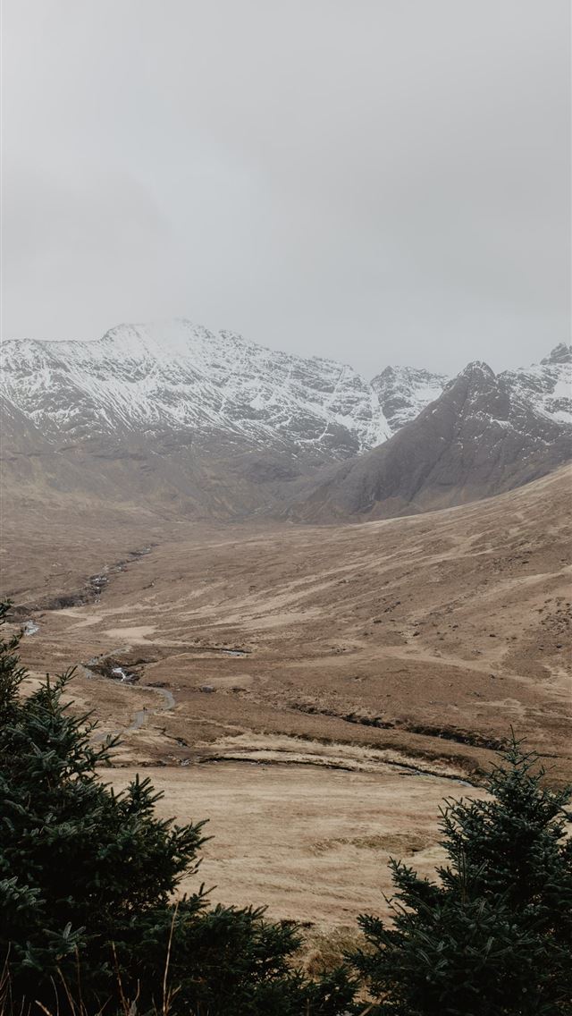 1290x2796 a view of a snowy mountain range from a distance - mountain iPhone Wallpaper