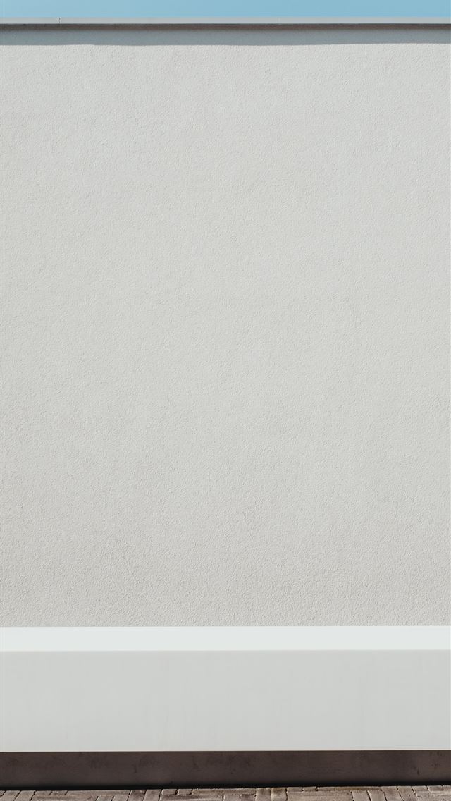 1290x2796 a black and white cat sitting on top of a white wa... - sky iPhone Wallpaper