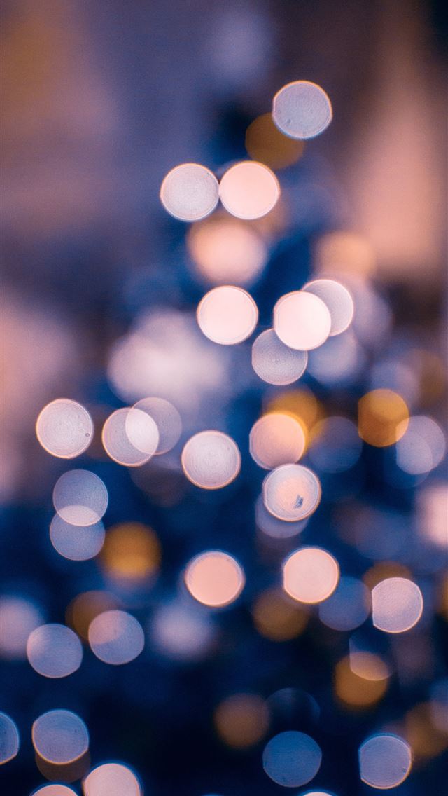 1290x2796 a blurry photo of a lit christmas tree - holiday iPhone Wallpaper