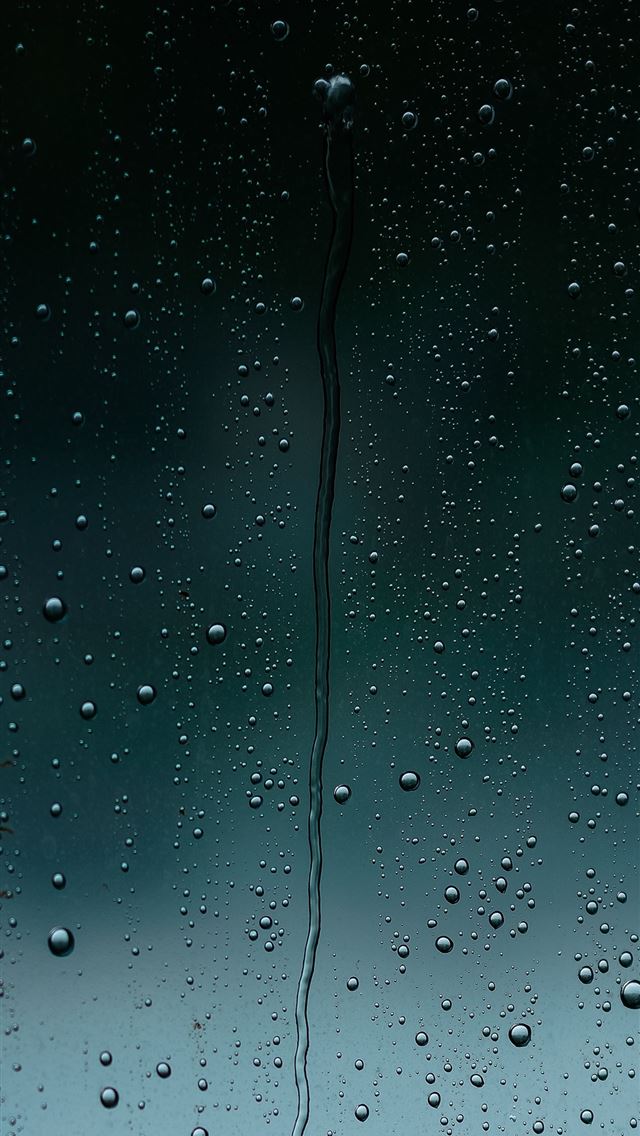 1290x2796 a close up of a window with drops of water -  iphone 14 Wallpaper
