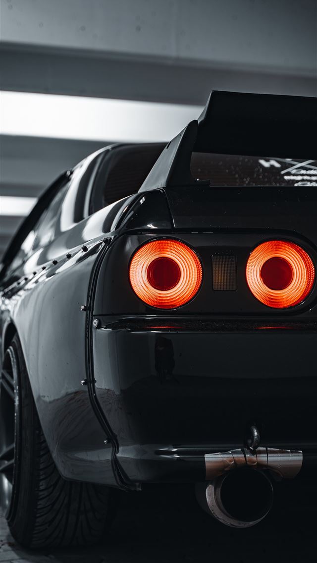 1290x2796 black car in a parking lot -  iphone 14 Wallpaper