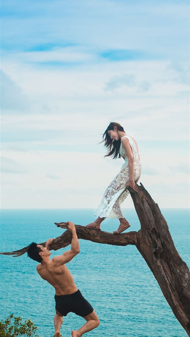 1290x2796 woman sitting on tree trunk with man holding on br... - love iPhone Wallpaper
