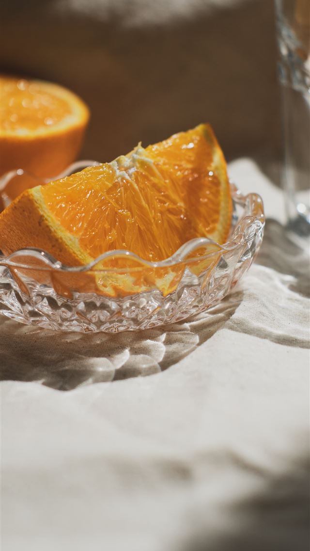 1290x2796 sliced orange fruit in clear cut glass bowl - textures iPhone Wallpaper