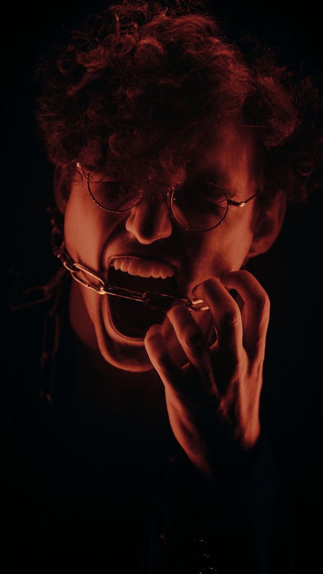 1290x2796 woman in black shirt holding eyeglasses - quotes iPhone Wallpaper