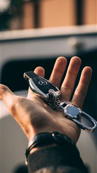 person holding Mercedes Benz fob wallpaper