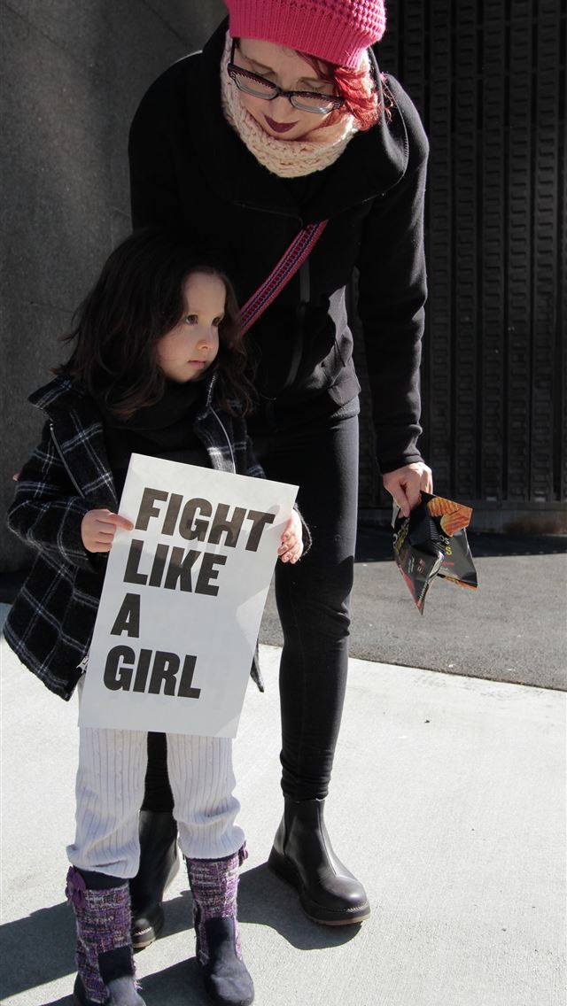 1290x2796 girl holding fight like a girl printed paper besid... - girl iPhone Wallpaper