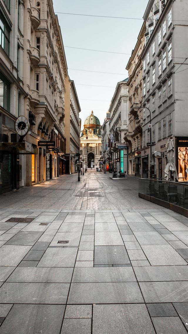1290x2796 people walking on sidewalk between buildings durin... - street iPhone Wallpaper