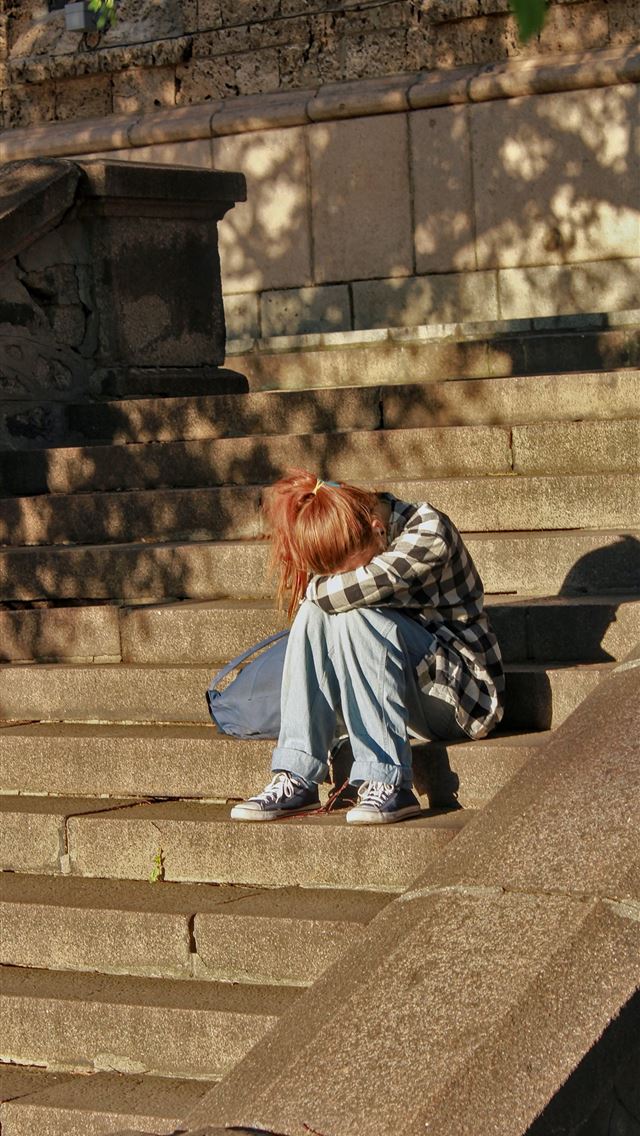 1290x2796 woman in black and white dress sitting on concrete... - girl iPhone Wallpaper