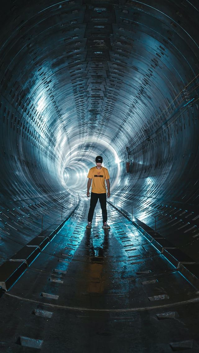1290x2796 low light photography of man standing inside tunne... - cool iPhone Wallpaper